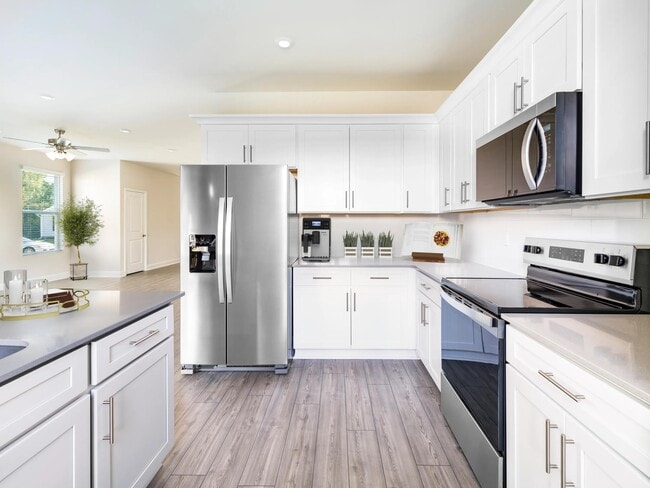 A bright, contemporary kitchen at Amavi Brier Creek, designed for everyday ease with Durham’s Brier Creek dining, shopping, and conveniences nearby.