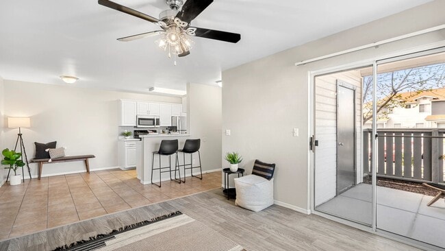 Sunlit open floor plan with tiled dining area, connecting effortlessly to the living room and kitchen.