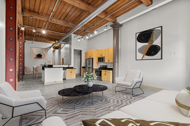 Modern loft apartment featuring exposed wooden beams