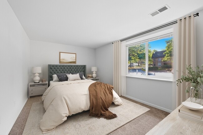 Step into the inviting ambiance of Fairway Apartments' spacious bedroom, featuring natural light and a tranquil view. This elegant retreat combines comfort and style. Explore your new home today!
