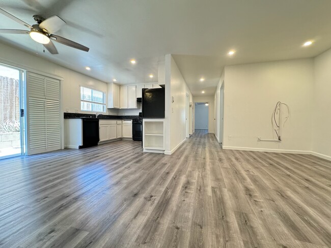 Large living room with recessed lighting, plantation shutters opening to private garden patio. Upgra - 1757 17th St Apartments Unit #3