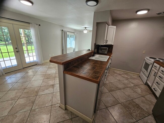 Kitchen eating/walkout and doorway around corner to bathroom, laundry, and lower level