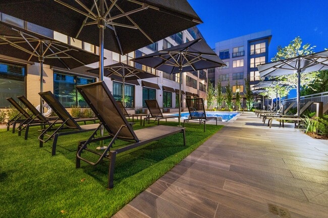 Resort style pool deck with shaded seating areas