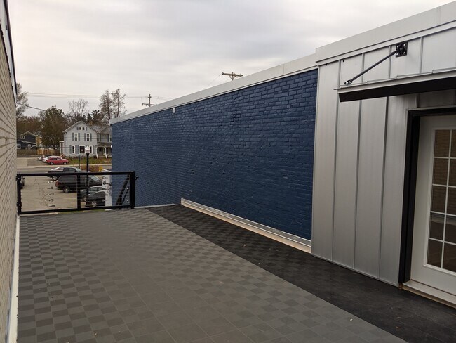 Shared patio area, entrance to apartment. - 130 E State St Unit 202