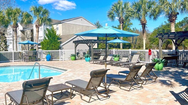 Discover poolside serenity on our spacious sundeck with abundant seating options under the sun. - The Enclave at Huntington Woods Apartments