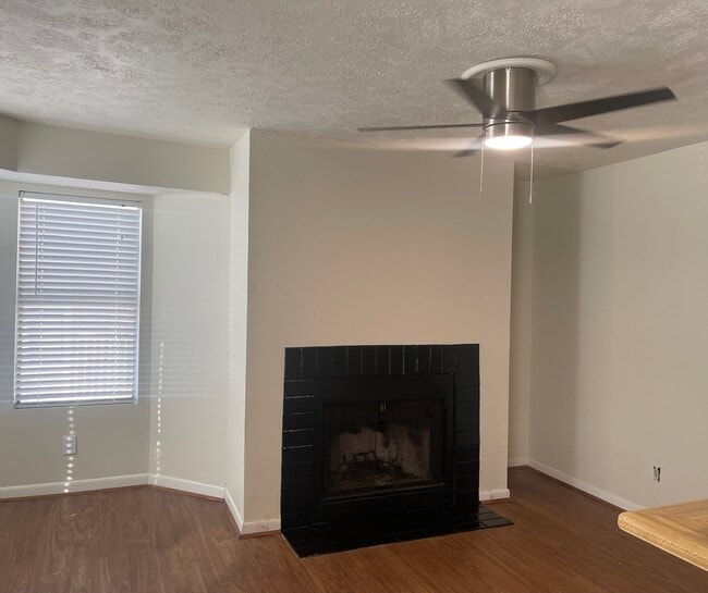 Open concept living room with fireplace - 4441 Old College Rd Unit #4201