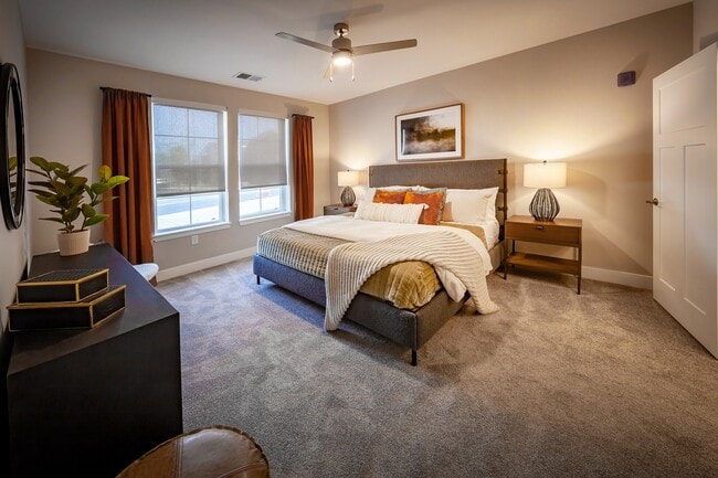 The primary bedroom suite with flexible furniture layout options, a walk-in closet, and a private en-suite bathroom.