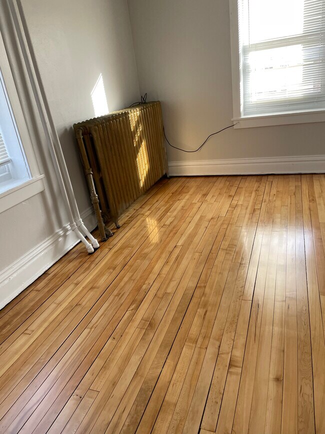 Back bedroom newly refinished hardwood floor - 432 E 7th St Unit 1