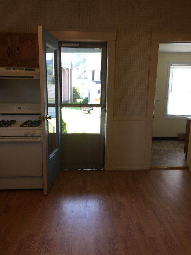 Kitchen with porch entry, and bathroom doorway. - 100 Park Ave Unit 1