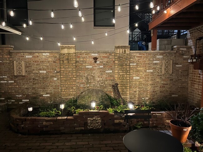 nighttime view of courtyard - canopy lit - 2446 W Thomas St Unit 1R