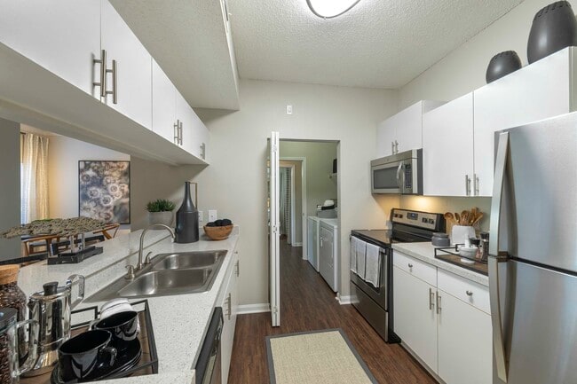 Kitchen with modern appliances and white cabinetry