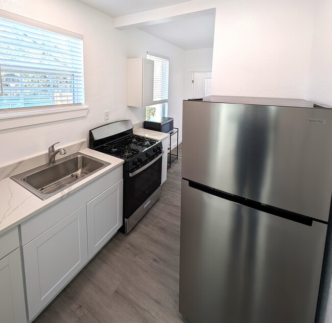 Kitchen with new refrigerator and oven - 407 Ripley Ave Apartments