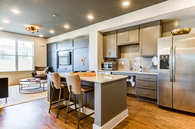 Community kitchenette complete with side-by-side refrigerator, microwave, and island seating