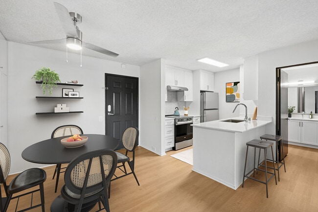 Renovated Package II kitchen and dining room with updated hard surface flooring - AVA Pacific Beach
