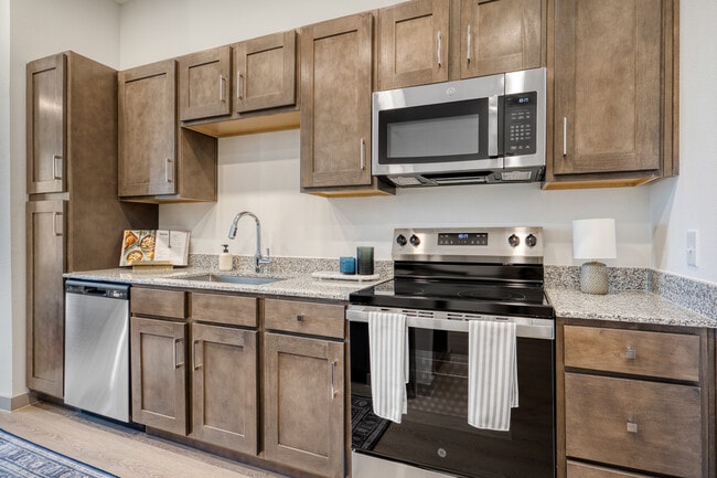 Modern kitchen featuring sleek cabinetry, contemporary finishes, and ample storage at Mesquite Trail