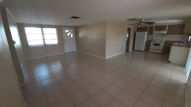 Photo - 2/1.5/1 1000 Sq. Ft. Spacious living room, Lanai, fenced in yard, and tile floors thoughout!