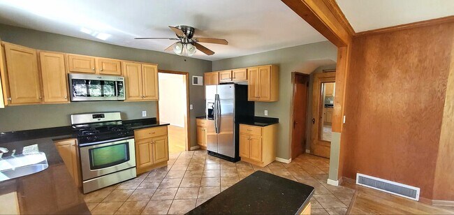 Additional kitchen view highlighting workspace and storage. - 2923 Arthur St NE