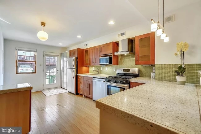 Beautiful countertops and kitchen exiting to parking pad