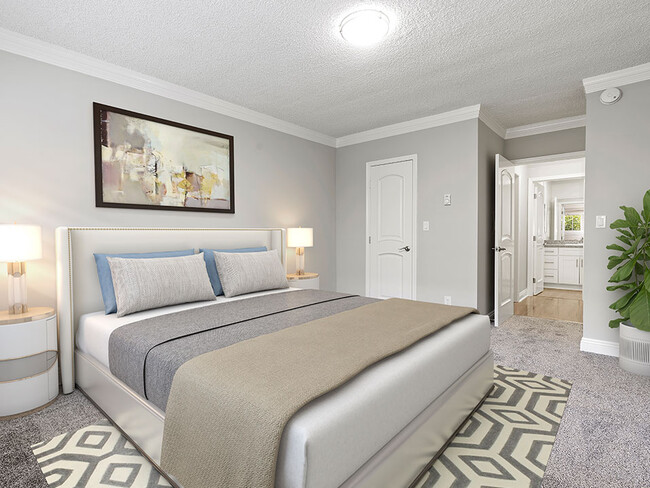 Well-lit carpeted bedroom with private bathroom. - Rose North Apartments