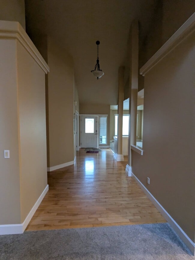 Towards the front door from the family room and kitchen with kitchenette