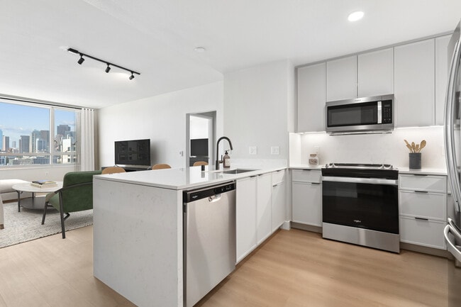 Signature Collection Phase I kitchen and living room with hard surface flooring