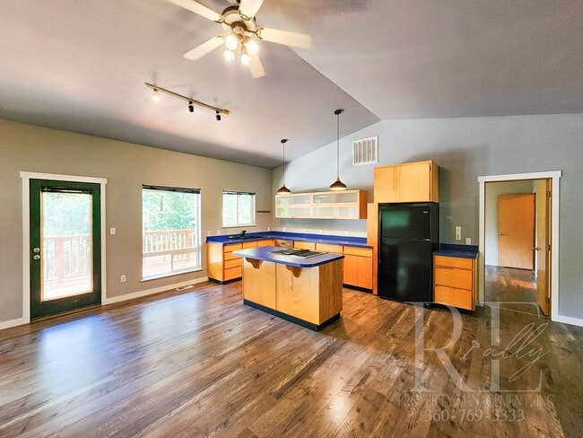 Photo - Vaulted Ceilings, Unique Designer Kitchen & Expansive Half-Acre Setting with Flexible Living Spaces