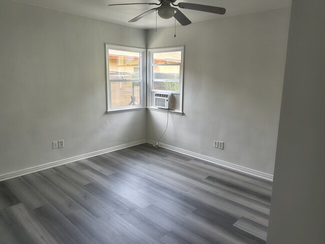 Primary bedroom with air conditioning and ceiling fan for added comfort - 2215 Carmona Ave