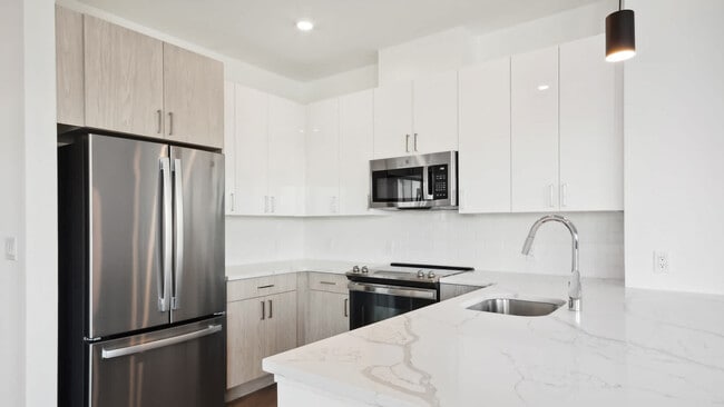 Kitchen with Stainless Steel Appliances and White Granite Countertops