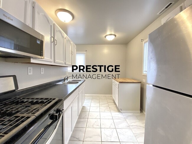 Photo - Updated Home with Central Air, Fenced Yard, and Two-Car garage!