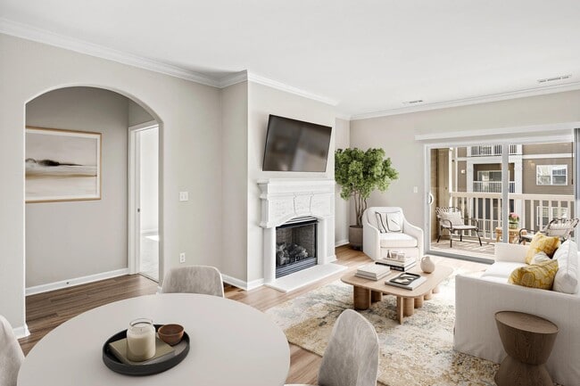 Open living and dining area with balcony access, abundant natural light, and a fireplace available in select homes for added warmth and character.