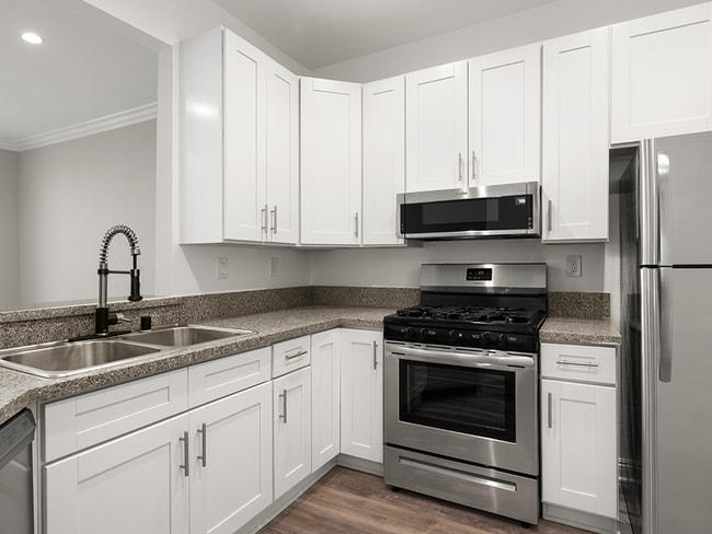 Kitchen with stainless steel fridge, oven, and microwave.