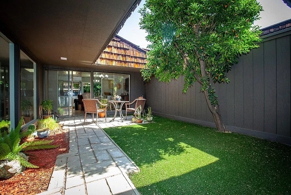 Courtyard has Kumquat tree & artificial grass.