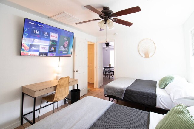 Bedroom with study area and 65" Roku TV - 5901 W Cypress St Casa