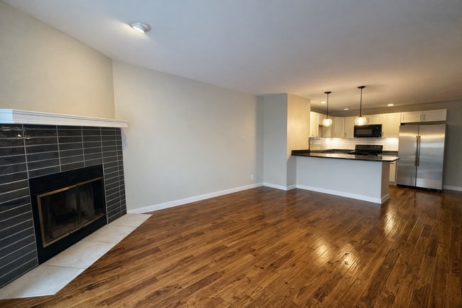 Open living space with a classic wood-burning fireplace. - 524 Superior St