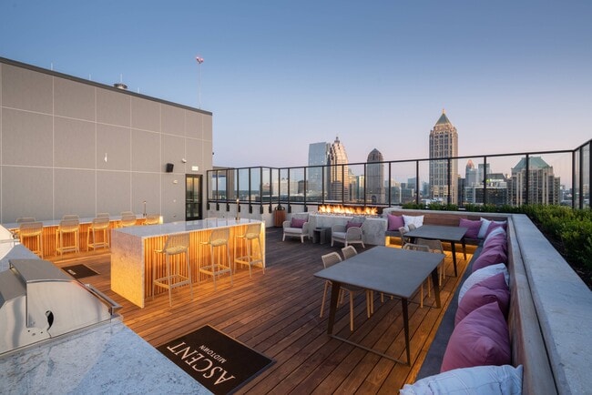 Rooftop lounge with outdoor kitchen, fireplace & spectacular views.