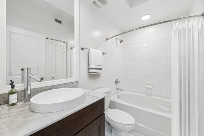 Renovated Package II bath with quartz countertop and oak cabinetry (in most homes)