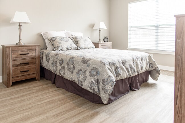 Typical Apartment Spacious Master Bedroom with Faux Wood Flooring - Green Wood Park Townhouses & Apartments