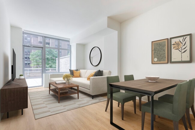Renovated Package I living and dining area with hard surface flooring - Avalon Morningside Park
