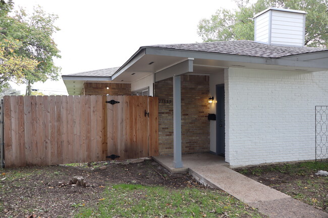 New fence, gate and inviting front porch to lounge on. - 13559 Red Fern Ln Townhome