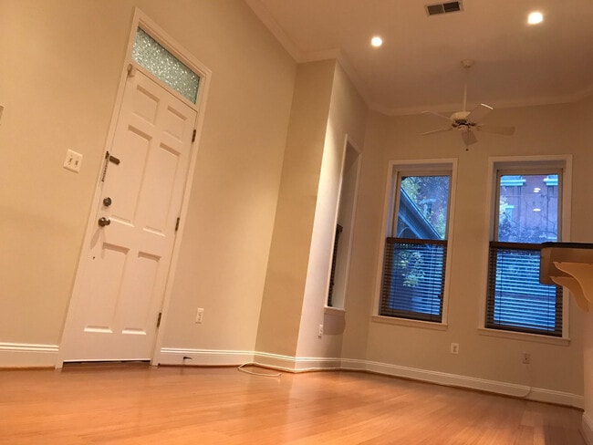 Living area with 11+ foot ceilings and ceiling fan.