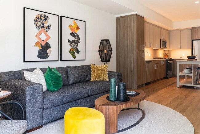 Open-concept home with warm wood-tone cabinetry, stainless steel appliances, and a connected living area designed for comfort and everyday ease.