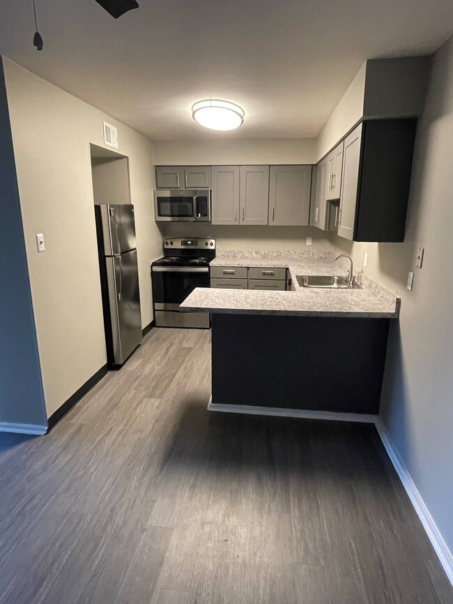 Upgraded Kitchen with Gray Cabinetry, Stainless Steel Appliances, New Countertops and Luxury Vinyl Plank Flooring