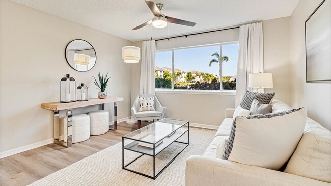 Bright living spaces with large windows and cheerful ceiling fans for an uplifting vibe. - Lexington Palms at the Forum