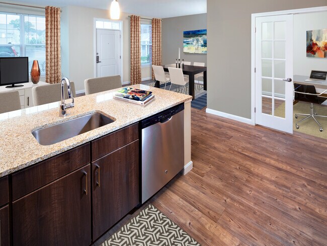 Classic Kitchen with chocolate pecan cabinetry, tile backsplash, laminate countertops, hard surface flooring, and stainless steel appliances