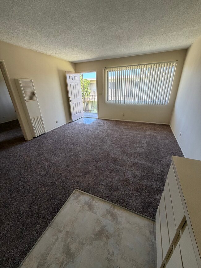 Living room from kitchen - 2133 Elden Ave Unit Elden East Apartments