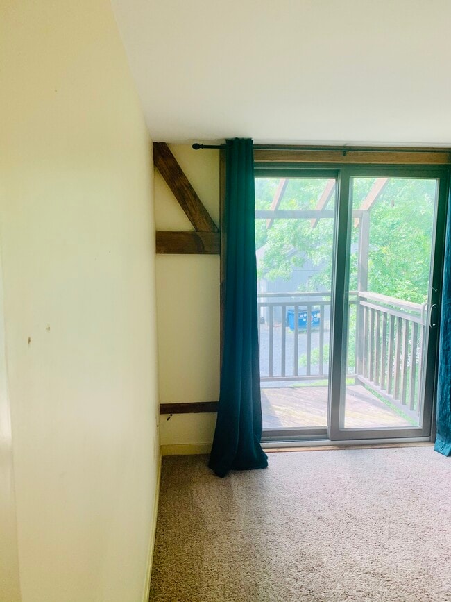 View in primary bedroom with balcony access - 7098 FERRY Rd Unit 1