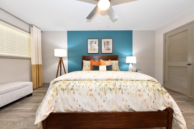 Cozy bedroom with hardwood-style flooring and ceiling fan