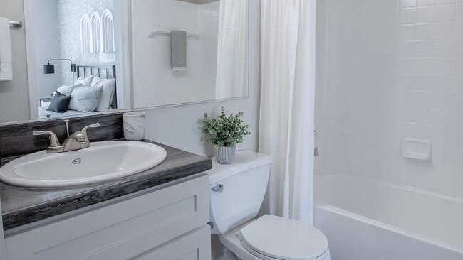 Immerse yourself in the exquisite design of our upgraded bathrooms, showcasing sleek black fusion countertops and vanity lighting!