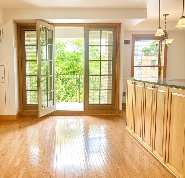 Dining space w/ large island & attached balcony - The Emerson