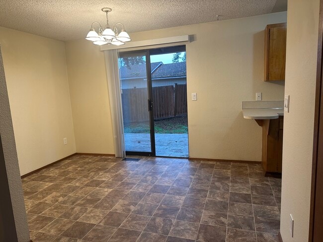 dining area off kitchen with sliding doors to back yard - 6439 Armar Rd Unit # 2